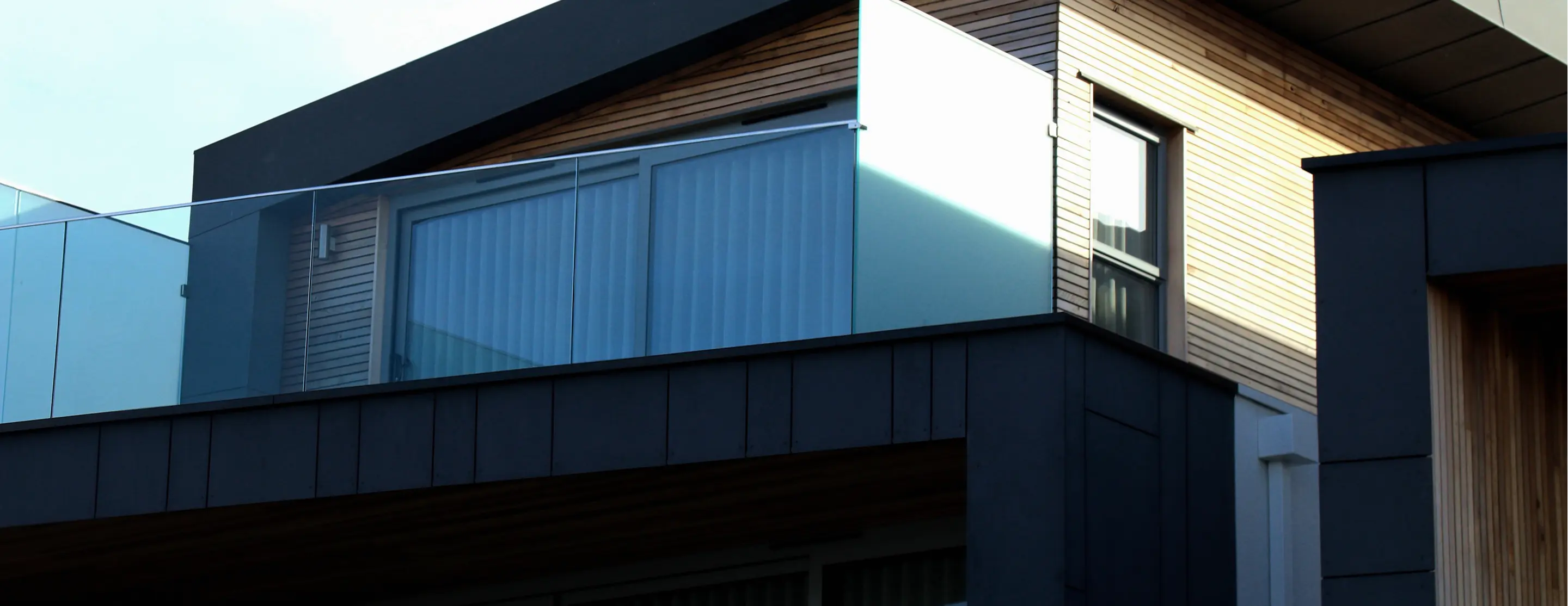 Modern dark-clad building exterior in late-day light
